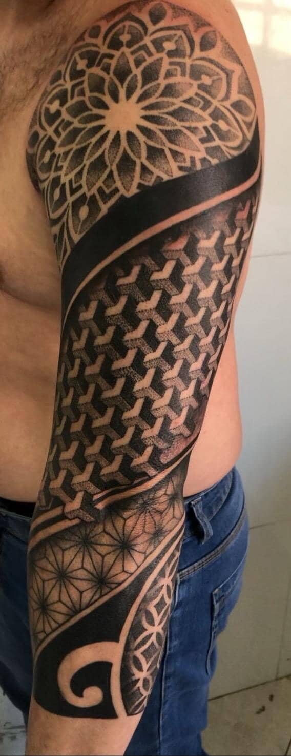 Tattoo by Ricardo Mendes, geometric blackwork sleeve with a mandala on the shoulder
